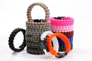 Parachute cord bracelets of different colors on a white backgrou