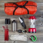 Camping Gear On Rustic Wooden Boards